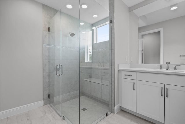 bathroom featuring vanity and a shower with shower door