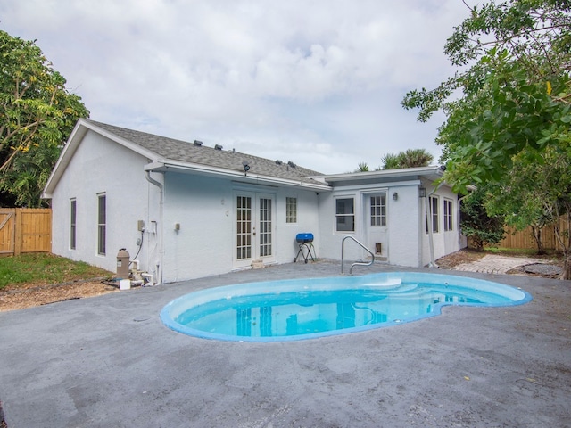 view of pool featuring a patio area and french doors