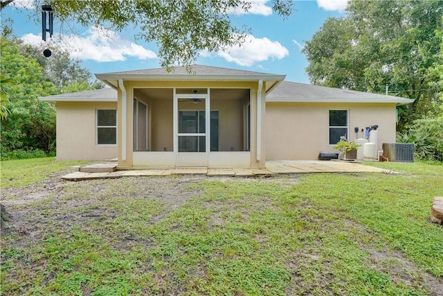 back of house with a patio area, central AC, a yard, and a sunroom