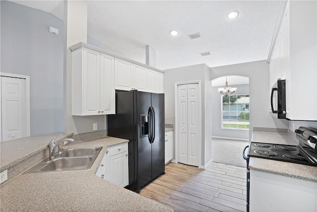 kitchen featuring sink, black appliances, white cabinetry, and light hardwood / wood-style floors