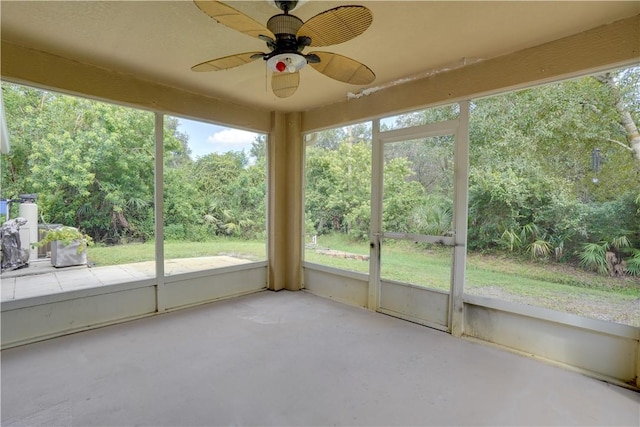 unfurnished sunroom featuring ceiling fan