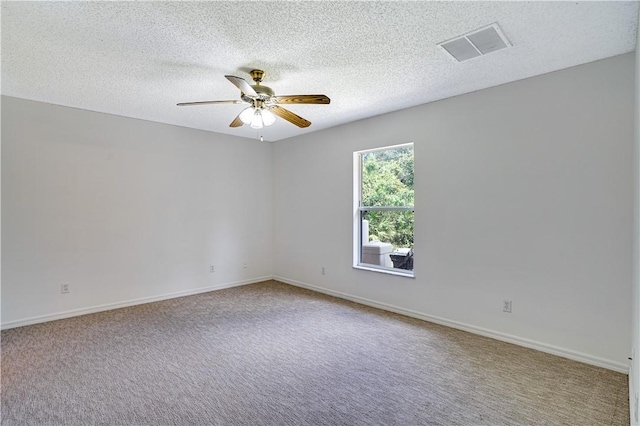 empty room featuring carpet floors, a textured ceiling, and ceiling fan