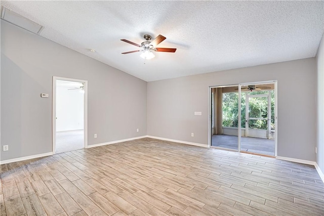 unfurnished room with ceiling fan, a textured ceiling, light hardwood / wood-style flooring, and vaulted ceiling