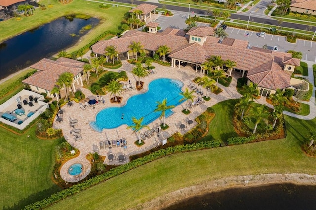 birds eye view of property with a water view and a residential view