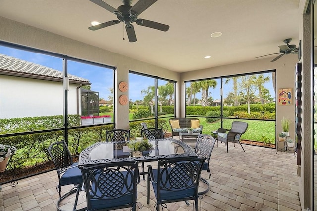 sunroom featuring a ceiling fan