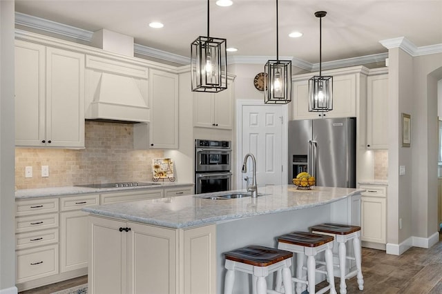 kitchen with stainless steel appliances, premium range hood, a sink, and ornamental molding