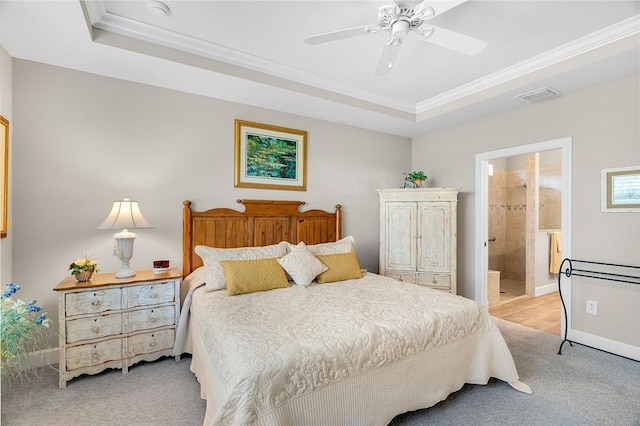 bedroom featuring light carpet, visible vents, a tray ceiling, and ornamental molding