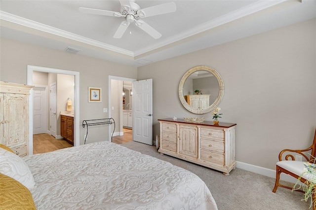 bedroom featuring visible vents, ensuite bathroom, light carpet, ceiling fan, and baseboards