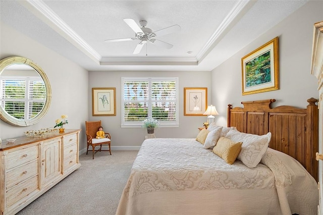 bedroom with crown molding, multiple windows, a raised ceiling, and light colored carpet