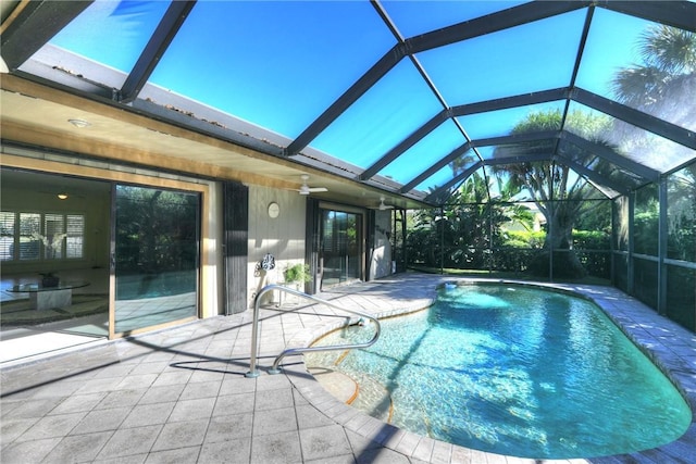 view of swimming pool with a patio and glass enclosure