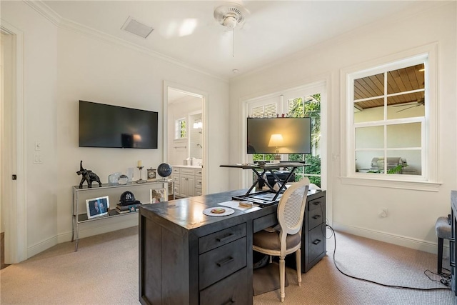 office space with crown molding, ceiling fan, and light colored carpet