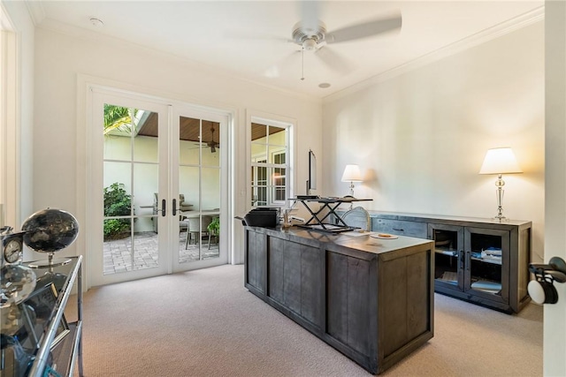 office space featuring crown molding, ceiling fan, french doors, and light colored carpet