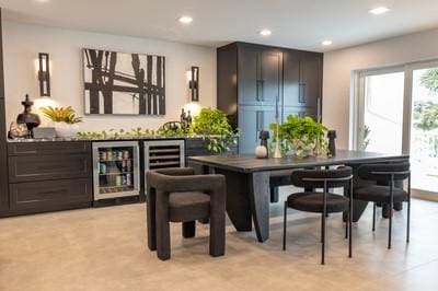 bar featuring dark brown cabinets and beverage cooler