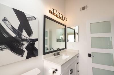 bathroom featuring vanity and toilet