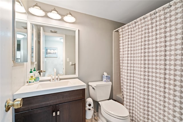 full bathroom featuring shower / bath combo, vanity, and toilet