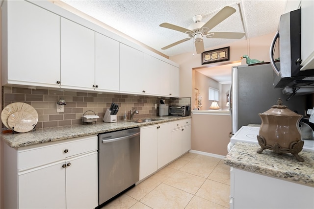 kitchen featuring white cabinetry, stainless steel appliances, a textured ceiling, and sink