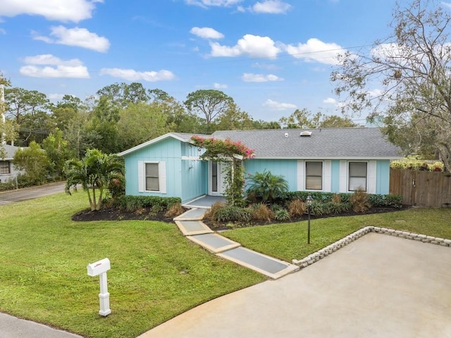 ranch-style home featuring a front yard