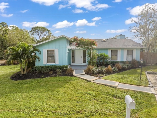 ranch-style home with a front lawn