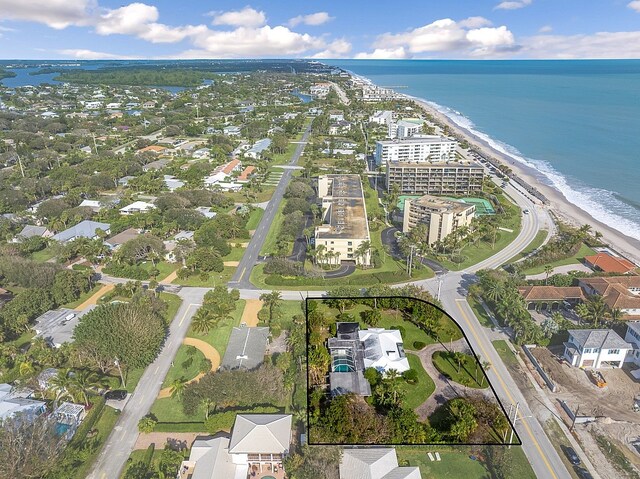 aerial view featuring a water view and a beach view