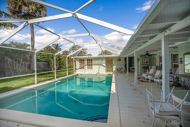 view of pool featuring a lanai, ceiling fan, and a patio area