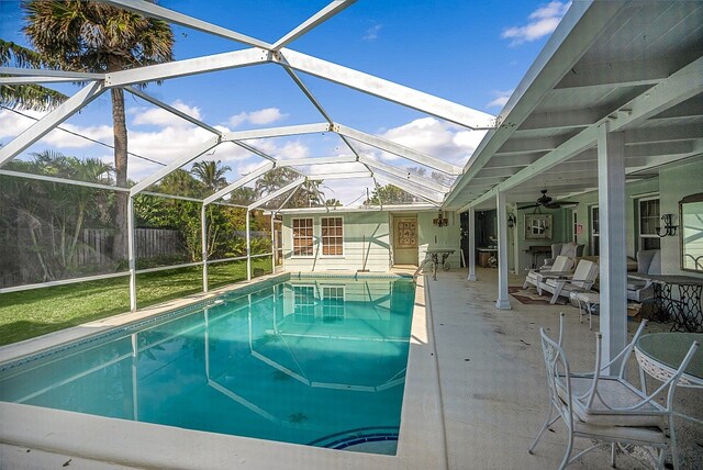 view of pool featuring a lanai, ceiling fan, and a patio area