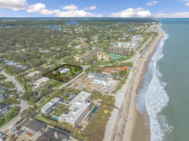 drone / aerial view featuring a view of the beach and a water view