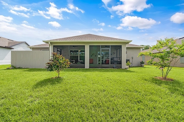 back of house with a yard and a sunroom