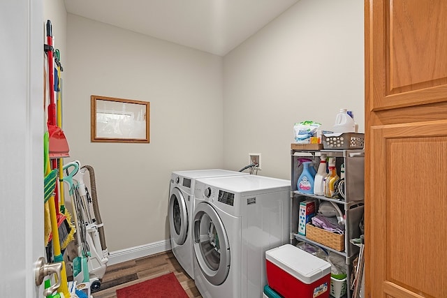 laundry room featuring separate washer and dryer and hardwood / wood-style flooring