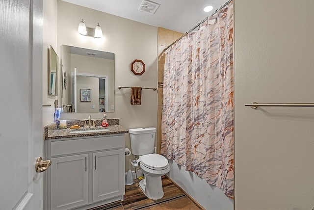 full bathroom with toilet, shower / bath combination with curtain, hardwood / wood-style floors, and vanity