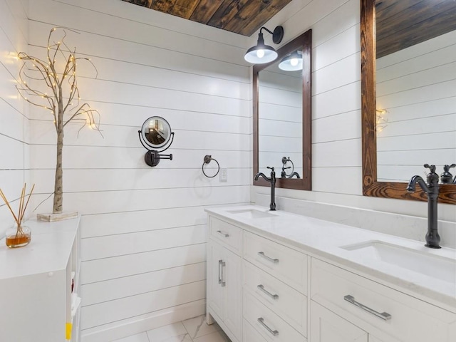 bathroom with vanity, wooden ceiling, and wooden walls