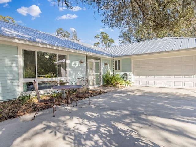 view of front facade featuring a garage and a patio