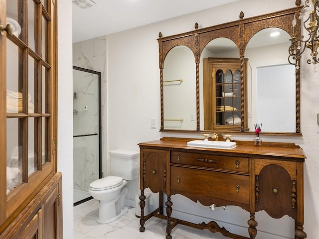 bathroom featuring vanity, toilet, and a shower with door