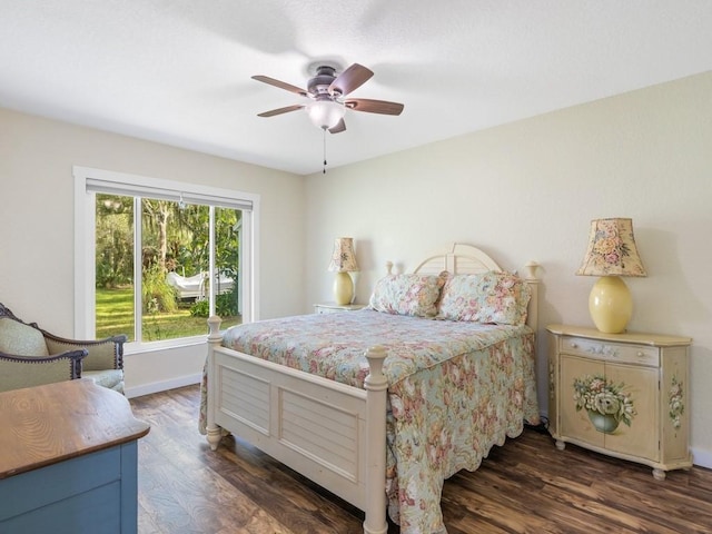 bedroom with ceiling fan and dark wood-type flooring