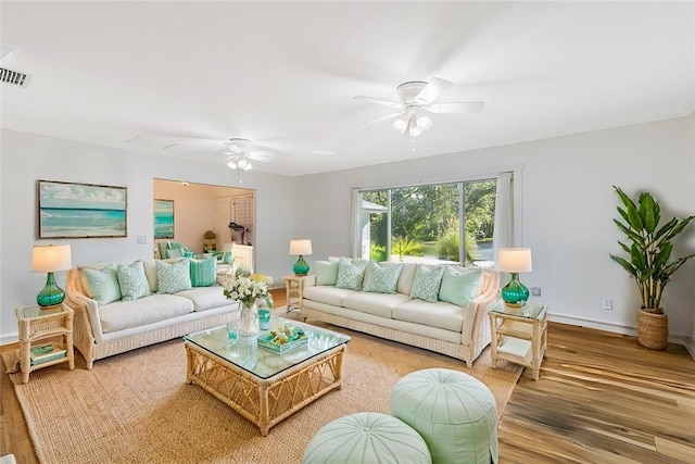 living room featuring wood-type flooring and ceiling fan