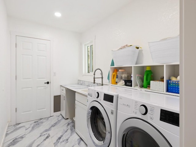 laundry room featuring cabinets, sink, and washer and dryer