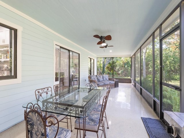 sunroom / solarium featuring ceiling fan