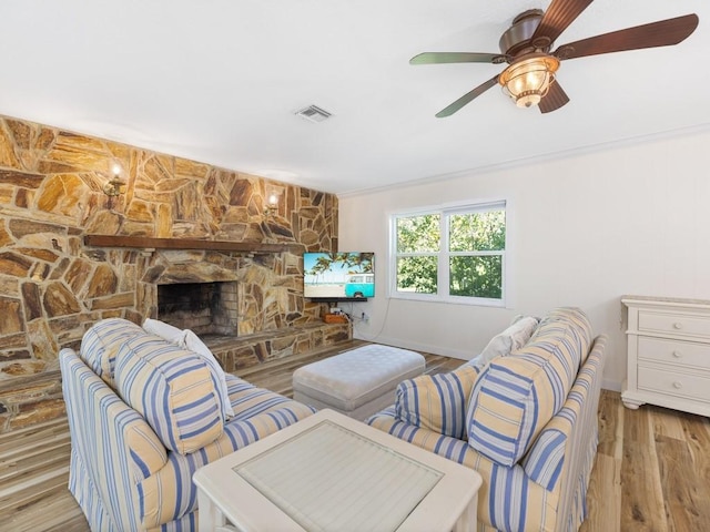 living room with light hardwood / wood-style floors and a fireplace