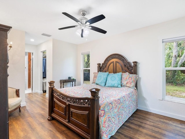 bedroom with ceiling fan, dark hardwood / wood-style floors, and connected bathroom