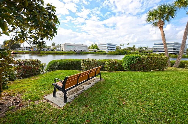 surrounding community featuring a water view and a lawn