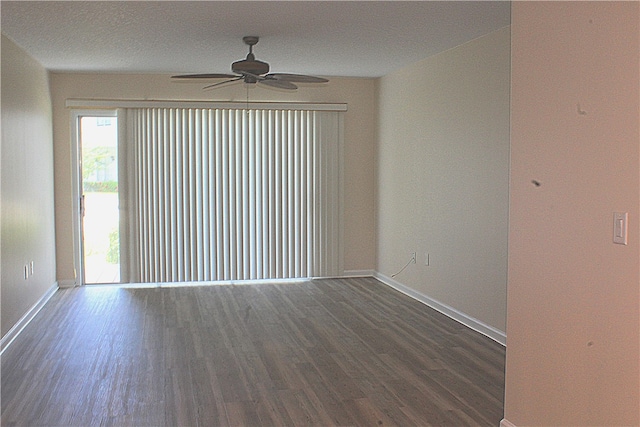 empty room with ceiling fan, a textured ceiling, and dark hardwood / wood-style floors