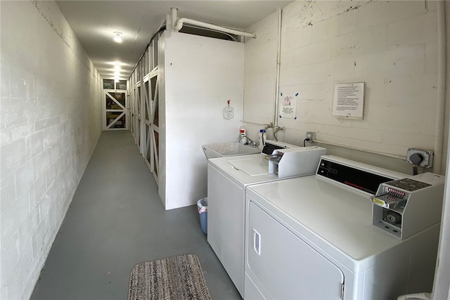 clothes washing area featuring washer and clothes dryer and sink