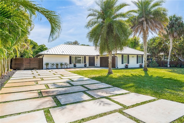 view of front of property with a patio area and a front lawn