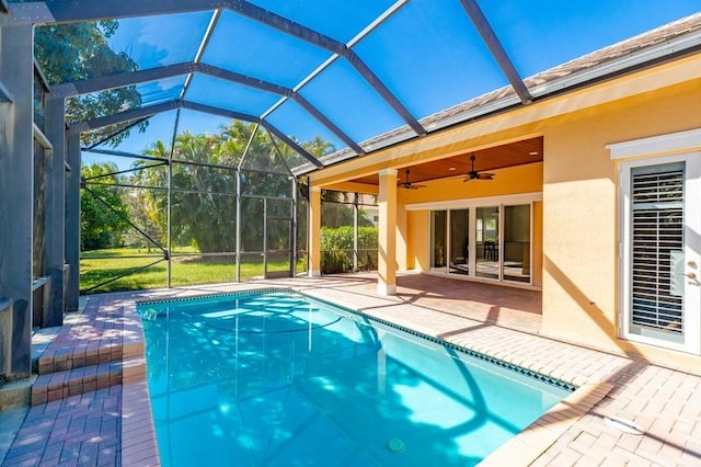 outdoor pool featuring a lanai, ceiling fan, and a patio