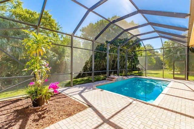 outdoor pool with glass enclosure and a patio area