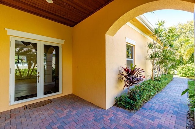 property entrance featuring french doors and stucco siding