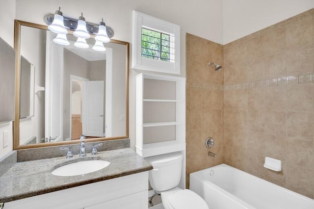 bathroom featuring vanity, shower / tub combination, and toilet