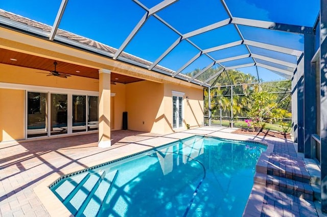 outdoor pool featuring a patio, a lanai, and a ceiling fan