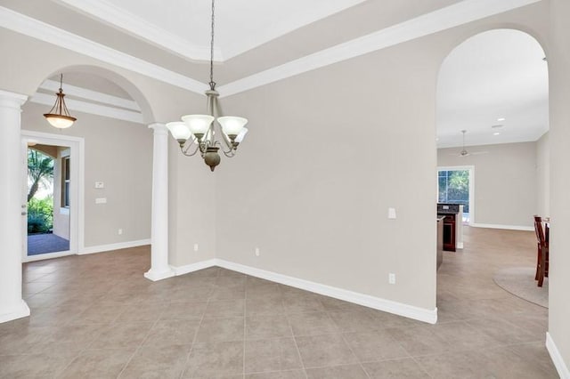 interior space with decorative columns, baseboards, arched walkways, and a wealth of natural light