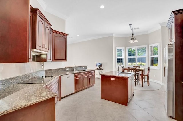 kitchen featuring crown molding, black electric stovetop, dishwasher, hanging light fixtures, and a kitchen island with sink