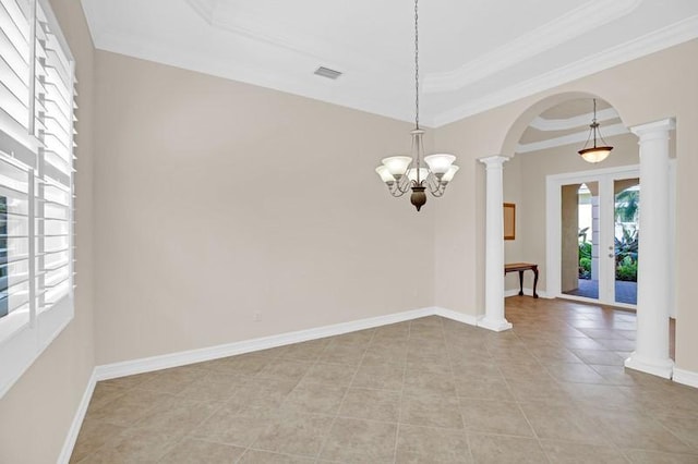 spare room featuring a raised ceiling, baseboards, arched walkways, and ornate columns